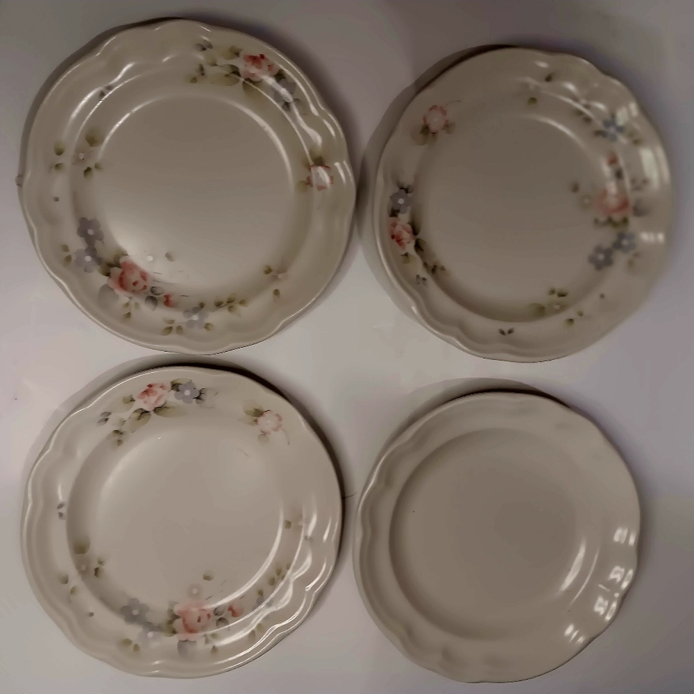 Three Pfaltzgraff salad plates with flower design.  One plain.